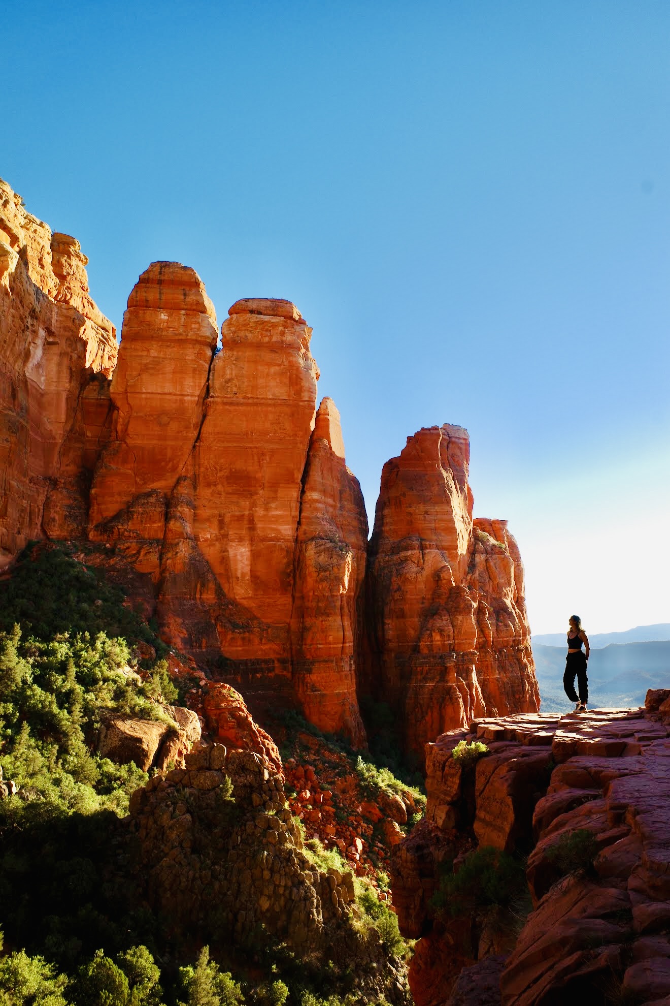 Alexa Bush standing on red rock formations in Sedona, Arizona